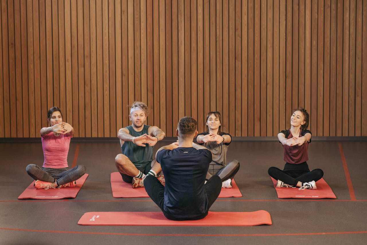 Services A diverse group practicing yoga in a studio with a focus on wellness and mindfulness.